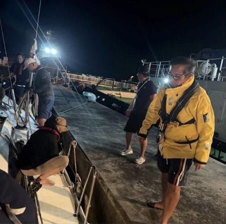 Sailors on a harbour wall at night on the Taiwan coast